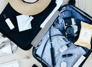 open suitcase with clothes and camera. travel. Des Moines Mom