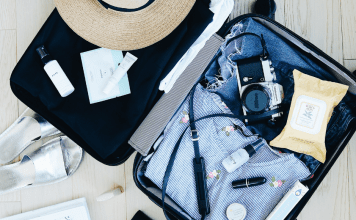 open suitcase with clothes and camera. travel. Des Moines Mom