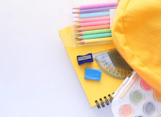 yellow backpack with school supplies. Back to School. Des Moines Mom