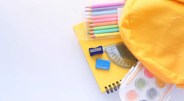 yellow backpack with school supplies. Back to School. Des Moines Mom