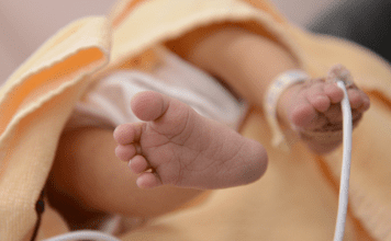 newborn baby toes with heart monitor NICU awareness