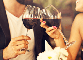 Couple toasting with wine glasses. date night restaurants in Des Moines. Des Moines Mom