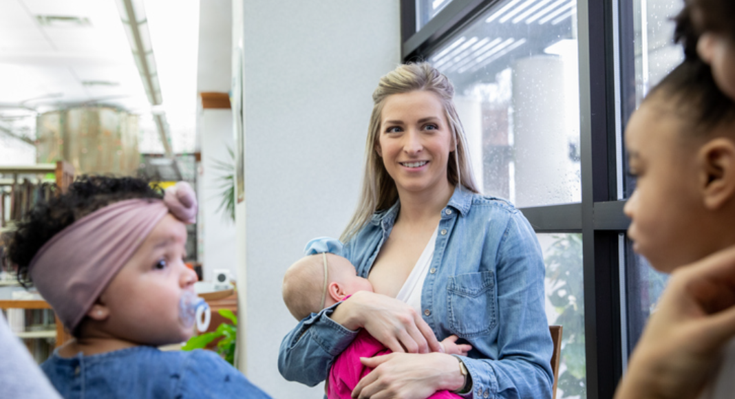 woman breastfeeding baby. Des Moines Mom