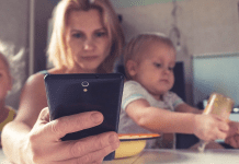 mom holding kids and phone