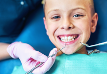 smiling kid in dentist chair