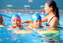 kids in swimming pool with kick boards